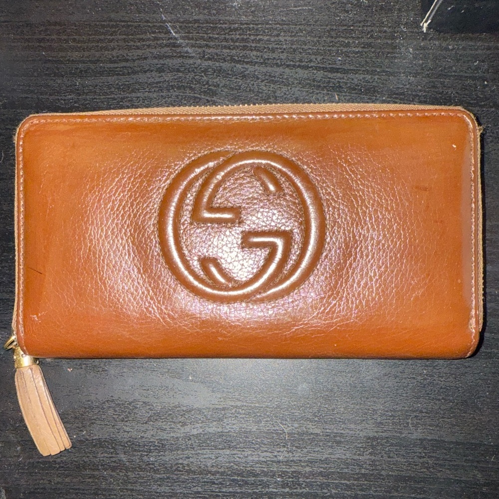 Brown Gucci Leather Wallet with Embossed Logo and Tassle